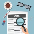 Searching job in newspaper with magnifying glass. Job concept.