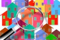 Searching new home concept image - concept image with colorful houses seen through the magnifying glass