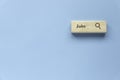 Searching for a new job, employment, a career, a job opportunity, or a work position concept. Wooden search bar isolated on a blue