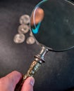 Searching for pennies with magnifying glass