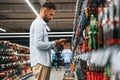 Searching for the tools. Man is in the hardware shop Royalty Free Stock Photo