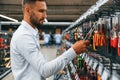Searching for the tools. Man is in the hardware shop Royalty Free Stock Photo