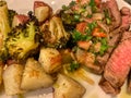 seared beef steak, baked potatoes and vegetable salad