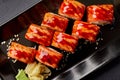 Seared salmon sushi rolls with unagi sauce and sesame served with pickled ginger and wasabi