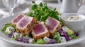 Seared tuna salad with microgreens and creamy dressing on a white plate Royalty Free Stock Photo