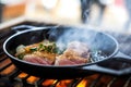 searing tuna steak in stainless steel pan with smoke Royalty Free Stock Photo