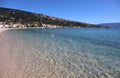 Seascape azure Adriatic Sea, mountains on the horizon, seagull above the surface of transparent water against the background of a Royalty Free Stock Photo