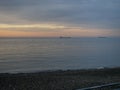 Seascape. Barges on the horizon. Dry cargo ships at sea. Black Sea at sunset