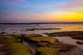 Seascape. Beach with rocks and stones. Low tide. Pink sunset. Slow shutter speed. Soft focus. Melasti beach, Bali, Indonesia Royalty Free Stock Photo