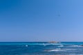 Seascape with beautiful blue sea and white waves in the distance lighthouse, seaplane in the air flies to the island of Formentera Royalty Free Stock Photo