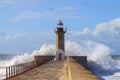 Seascape with big wave crashes at the lighthouse. Maritime landscape. Porto landmark, Portugal. Storm on the stone jetty with very