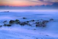 Seascape in blue-orange twilight with soft wave motion blur