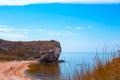 seascape. Blue sea and rocky shore with sandy beach and tourists. Travel and tourism