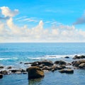 Seascape with bright blue water and rocky shore Royalty Free Stock Photo