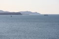 Seascape with capes, mountains and fishing vessels at anchor. Marine bay, good weather.