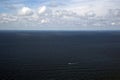 Seascape from the clouds with a passing small ship. Royalty Free Stock Photo