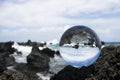 Blue Ocean Waves Breaking on Black Lava Rock Captured in Glass B Royalty Free Stock Photo