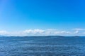 Seascape with a convoy of military vehicles on the roads.