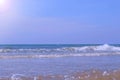 Seascape with curly long foamy rolling in tube waves in stormy sea at sunny day. Royalty Free Stock Photo