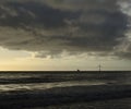 Seascape at dawn, clouds and wind turbine