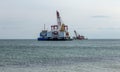 Seascape with an excavator. Deepening maritime expedition for cargo ships. Sea view with a sea crane and dragger for cleaning and