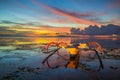 Seascape. Fisherman boat jukung. Traditional fishing boat at the beach during sunrise. Colorful sky. Amazing water reflection. Royalty Free Stock Photo