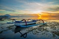 Seascape. Fisherman boat jukung. Traditional fishing boat at the beach during sunrise. Colorful sky. Amazing water reflection.