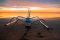 Seascape. Fisherman boat jukung. Traditional fishing boat at the beach during sunrise. Water reflection. Sanur beach, Bali,