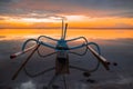 Seascape. Fisherman boat jukung. Traditional fishing boat at the beach during sunrise. Water reflection. Sanur beach, Bali,