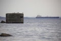 Seascape with flooded military concrete reinforcement and seagulls sitting on it