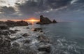 Dramatic clouds at sunrise hovering over sea