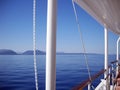 Blueness of Ionian sea, islands and sky, and whiteness of boat Royalty Free Stock Photo