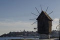 Seascape of isthmus with old wooden windmill between ancient Mesembria and new town Nessebar, Black Sea