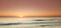 Seascape and landscape of a beautiful orange sunset on the west coast of Jutland in Loekken, Denmark. Sun setting on the