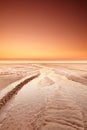 Seascape and landscape of golden sunset on the west coast of Jutland in Loekken, Denmark. Sun setting on the horizon on