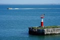 Seascape with a lighthouse and a military boat on the horizon in the Kerch Strait.