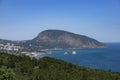 Seascape with a lonely mountain and houses at the foot of the mountains. Black Sea Royalty Free Stock Photo