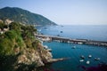 Seascape with long breakwater near marina of Camogli, Liguria, Italy