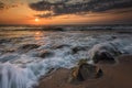 Seascape with long exposed waves and round rocks