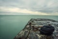seascape with long exposure. dramatic sky, surface of water and old pier. Royalty Free Stock Photo