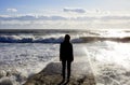 Seascape. Marine landscape with the figure of a woman. Wave on the sea breakwater. Royalty Free Stock Photo