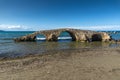 Seascape with medieval bridge in the water at Argassi beach, Zakynthos island, Greece