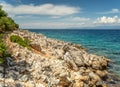 Seascape, Mediterranean coast. White rocks stones and blue water, sky with clouds Royalty Free Stock Photo