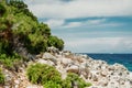 Seascape, Mediterranean coast. White rocks stones and blue water, sky with clouds Royalty Free Stock Photo