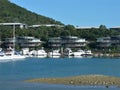Seascape with mooring yachts in the marina, the marina with houses, in the blurred background Mountains