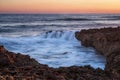 Motion blur and water flowing over the coral cliff