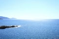 Seascape with mountains and rocks at dawn, beautiful blue water and sky.