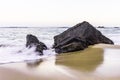 Seascape with the ocean in motion at sunset in sandy Adraga Beach Royalty Free Stock Photo