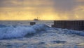 Seascape Sunrise Ocean Waves and Shrimp Boat on Horizon Royalty Free Stock Photo