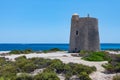Seascape with an old tower and a speeding boat on the sea Ibiza Royalty Free Stock Photo